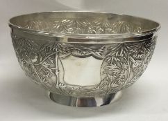 A Chinese export silver bowl embossed with birds and bamboo. Marked to base.