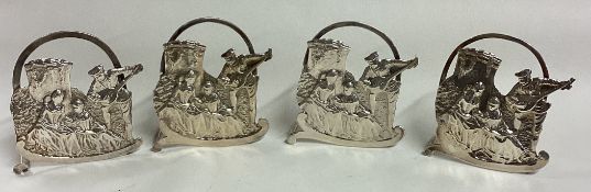 A set of four Victorian silver pierced menu holders of musical designs. London 1899.