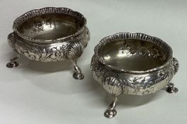 A chased pair of Victorian silver salts embossed with flowers. London 1855.