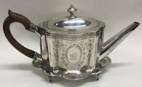 A good Georgian silver teapot on stand engraved with flowers and foliage. London 1788/1789.
