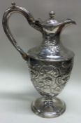 A heavy embossed George III silver wine jug. London 1800.