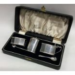 A good stylish silver three piece cruet set of shaped form. Birmingham.