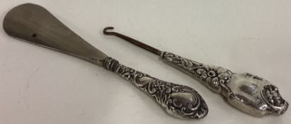 A 20th Century silver handled shoe horn together with a silver handled button hook.