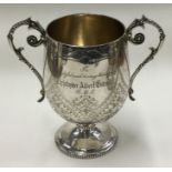 A Vctorian silver two handled cup with engraved decoration. London 1876. By H J Lias & Son.