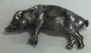 A silver figure of a pig.