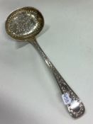 EXETER: A rare chased silver sifter ladle embossed with flowers. 1854. By Edwin Sweet.