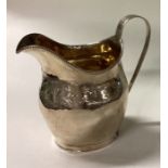 A George III silver cream jug with bright cut decoration. London 1801.