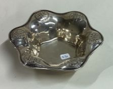 LIBERTY & CO: A chased silver dish. Birmingham 1912.