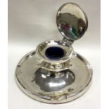 A massive circular silver capstan inkwell of stylised form with hinged top. Birmingham.