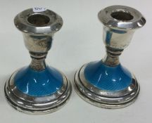 A pair of silver and enamel candlesticks. Birmingham 1935.