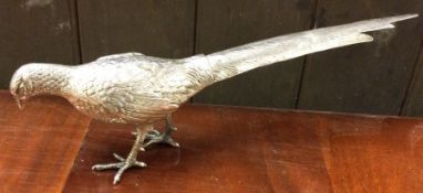 A Continental silver table toy moedelled as a figure of a pheasant with articulated wings.