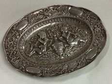 A heavy 19th Century chased silver dish embossed with cherubs.