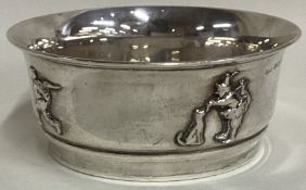 A chased silver christening bowl embossed with figures. Birmingham 1923. By D&B.