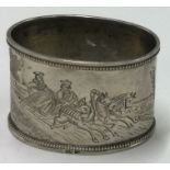 An early 20th Century Russian silver napkin ring engraved with equestrian scenes.