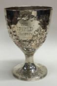 A large Victorian silver goblet embossed with flowers and beads. London 1873.