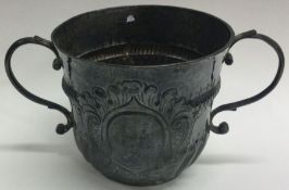 A Queen Anne silver porringer. London 1714.