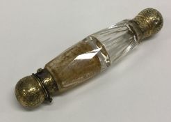 A Victorian silver gilt double ended scent bottle engraved with flowers. By Sampson Mordan & Co.