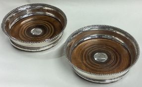 A pair of George III silver crested coasters. Birmingham.