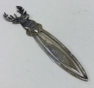 A silver bookmark with stag decoration.