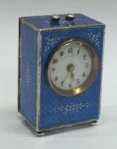 A silver and blue enamelled desk clock. Marked to base.