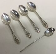 A set of four Edwardian silver pierced coffee spoons together with a bean top coffee spoon.