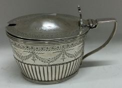 An engraved Victorian silver mustard pot. London 1885.