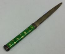 A silver and green enamelled letter opener.
