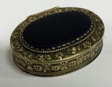 An early 18th Century silver and gem stone snuff box with embossed decoration.