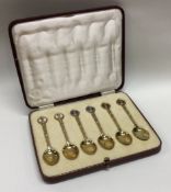 A cased set of silver gilt and enamel commemorative Coronation spoons.