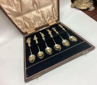 An attractive set of six silver gilt teaspoons decorated with musicians.