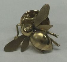 A small 18 carat gold badge in the form of a bee.