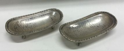 A pair of Continental silver dishes on ball feet with hammered decoration. Marked to bases.