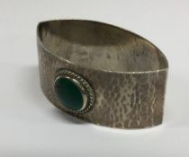 LIBERTY & CO: A 20th Century silver and green stone napkin ring.