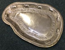 An Indian metalware tray embossed with elephants.