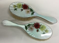 A pair of silver and enamelled flower brushes. London 1957.