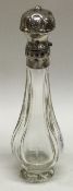 A silver mounted glass scent bottle with hinged top.