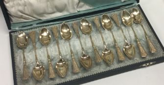 A boxed set of twelve heavy silver coffee spoons.