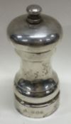 A silver pepper grinder. London.