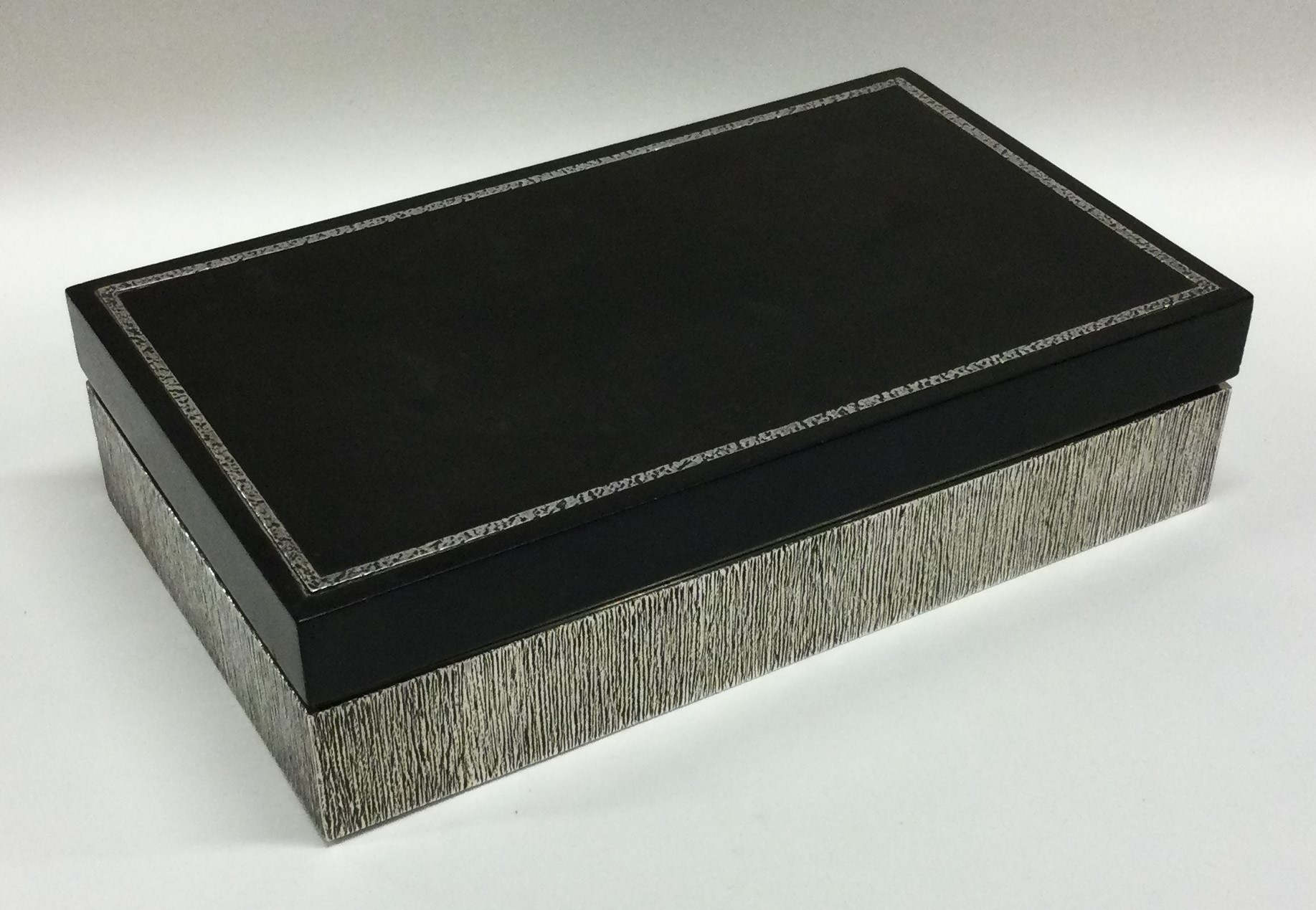 A heavy silver cigar box with bark finish. London 1975. By House of Lawrian.