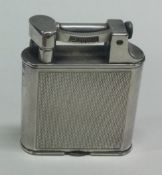 DUNHILL: An engine turned silver plated lighter.