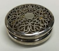A heavy circular silver box with pierced lid. London 1906. By William Comyns.