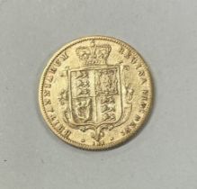 An 1877 Victoria bun shield back half Sovereign.