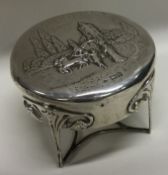 An Edwardian castle top embossed silver jewellery box on feet. London 1904.