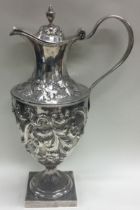 A large chased 18th Century silver wine jug with central armorial. London 1777.
