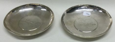 KWAN WO OF CANTON: A pair of silver dishes with coins to centres.