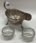 An Edwardian silver sauce boat together with a pair of salts. Birmingham.