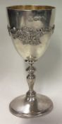 A silver goblet with vine pattern.