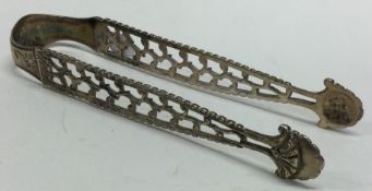 An 18th Century bright-cut pair of silver pierced sugar / ice tongs.
