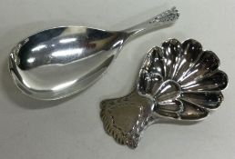 A good Georgian style silver caddy spoon with fluted bowl together with one other.