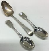 EXETER: A pair of silver fiddle pattern dessert spoons together with a table spoon.